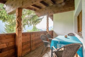 a porch with a blue table and chairs on it at Ferienhaus Zech in Marul