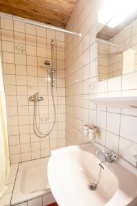 a white bathroom with a shower and a sink at Ferienhaus Zech in Marul