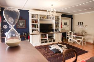 a living room with a table with a vase on a table at MacGregors Guest House in Pretoria