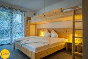 a bedroom with a bunk bed and a ladder at Gita´s Haus in Rust