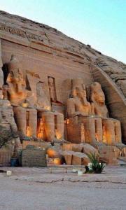 a large stone wall with statues on it at Hllol Hotel Abu Simbel in Abu Simbel