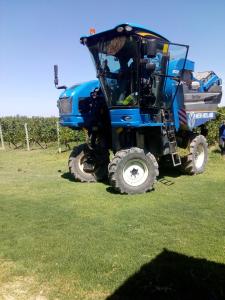 a large blue truck is parked in a field at Posada Cavieres Wine Farm in Maipú