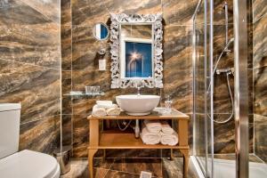 a bathroom with a sink and a mirror at Julina Boutique Living in Mosta +136 photos