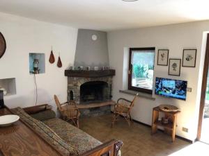 a living room with a couch and a fireplace at Baita Agostina in Gravedona