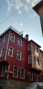 a red building with windows on the side of it at Emirganlı Ottoman House in Istanbul