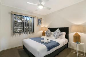 a bedroom with a large bed and a window at Family-Size Duplex in Quiet Neighbourhood in Brisbane