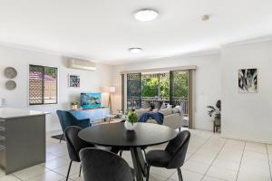 a living room with a table and chairs at Family-Size Duplex in Quiet Neighbourhood in Brisbane