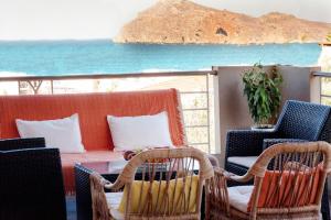 a patio with chairs and a table and a couch at Stamatakis Boutique Studios in Platanias
