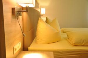 a hotel room with two beds and a yellow pillow at Grüner Hof in Zell am Harmersbach