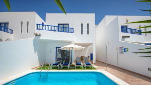 a large white swimming pool in a house at Villas Puerto Rubicon in Playa Blanca