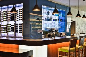 a bar in a restaurant with chairs and lights at Botanique Hotel Prague in Prague