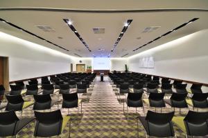 an empty room with chairs and a screen at Botanique Hotel Prague in Prague