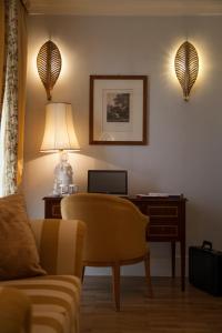 a living room filled with furniture and a lamp at Relais Villa San Martino in Martina Franca
