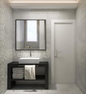 a bathroom with a sink and a mirror and a door at Twister Apartments in Budva