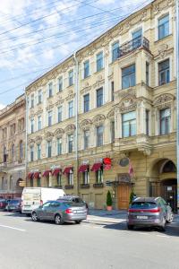 un gran edificio con coches estacionados frente a él en Casa Leto, en San Petersburgo