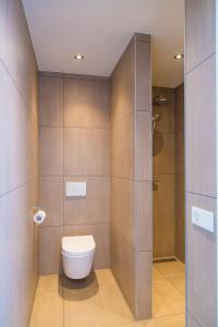 a bathroom with a toilet and a shower at Appartement Middelburg4you in Middelburg