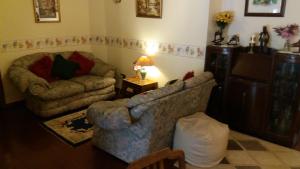 a living room with a couch and a chair at Sunnyside B&B in Balloch