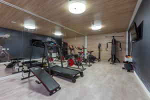a gym with several tread machines in a room at Hotel Las Arenas in Can Pastilla
