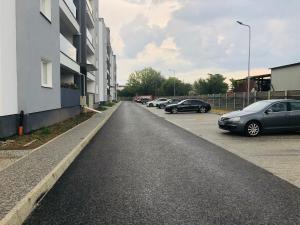 an empty parking lot with cars parked next to a building at Roxi's Apartment in Sibiu