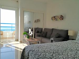 a living room with a bed and a couch at Adeje300, Playa Paraíso in Playa Paraiso +38 photos