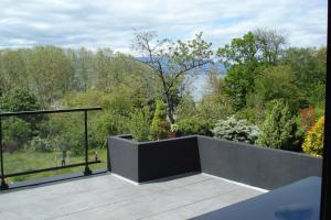 a view of a garden from the balcony of a house at LEMAN in Thonon-les-Bains