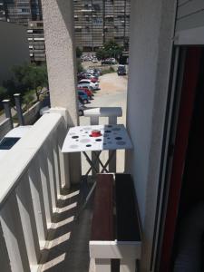 a table on the balcony of a building at Zdenka Studio Split in Split