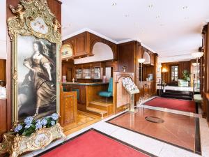 a living room with a large painting of a woman at Living Hotel Berlin Mitte in Berlin