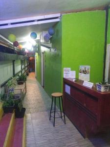 a green room with a counter and a stool at RedDoorz Syariah near Paradiso Beach Sabang in Sabong