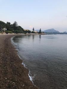 a beach with a rocky shoreline and the water at Villa Silvia in Casteldaccia