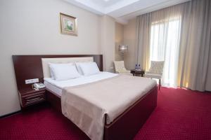 a hotel room with a large bed and a window at Marionn Hotel in Tbilisi City