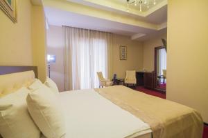 A bed or beds in a room at Marionn Hotel
