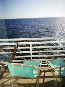 two chairs sitting on the deck of a cruise ship at Aquarius Loft in Callao Salvaje