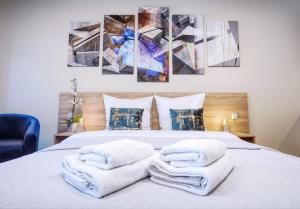 - une chambre avec un lit et des serviettes dans l'établissement RAJSKA 3 by PI Apartments, à Cracovie