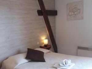 a bed in a room with a wooden headboard at Hôtel Restaurant de l'Abbaye in Clairvaux