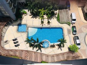 an overhead view of a swimming pool with palm trees at One Palm Tree Villas across NAIA-T3 in Manila