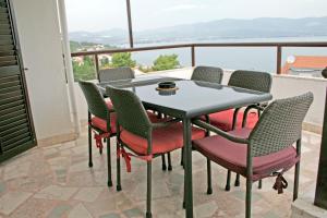 a table and chairs on a balcony with a view at Apartments Villa Zvonimir in Slatine