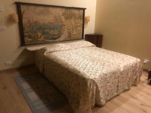 a bed in a room with a painting on the wall at La Capannaccia - Venice in Venice