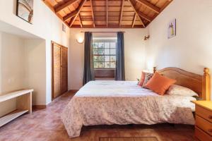 a bedroom with a large bed and a window at La Solanita in Puntagorda