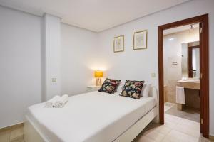 ein weißes Schlafzimmer mit einem Bett und einem Badezimmer in der Unterkunft LEEWAYS APARTMENT I in GRAN VÍA in Madrid