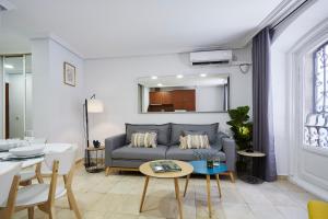 ein Wohnzimmer mit einem Sofa und einem Tisch in der Unterkunft LEEWAYS APARTMENT I in GRAN VÍA in Madrid