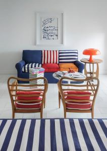 a living room with a couch and two chairs at Maison La Minervetta in Sorrento