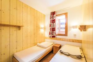 Tempat tidur dalam kamar di Residence Les Brigues - maeva Home