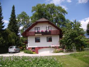 a house with a balcony with flowers on it at APARTMA ANTON in Bled