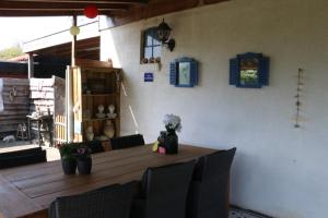 a dining room with a table with chairs and blue shutters at Bed & Breakfast de Runde in Emmer-Compascuum