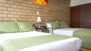 Voodi või voodid majutusasutuse Hotel Portal de Milán toas