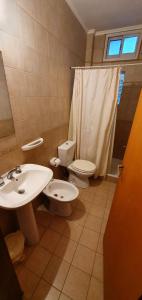 a bathroom with a sink and a toilet and a window at Alojamiento Tía Silvia in San José +25 photos