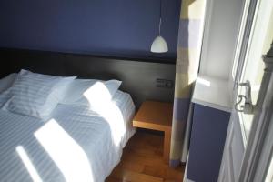 Postel nebo postele na pokoji v ubytování Hôtel de charme L'Orée du Parc