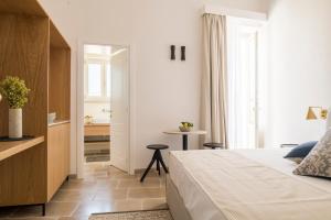 a hotel room with a bed and a bathroom at Palazzo Mulini in Monopoli