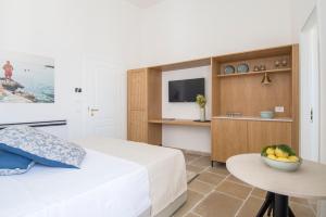 a bedroom with a bed and a table with a bowl of fruit at Palazzo Mulini in Monopoli