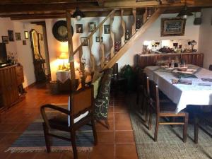 a dining room with a table and a staircase at Casa da Palmeira in Outeiro da Cortiçada